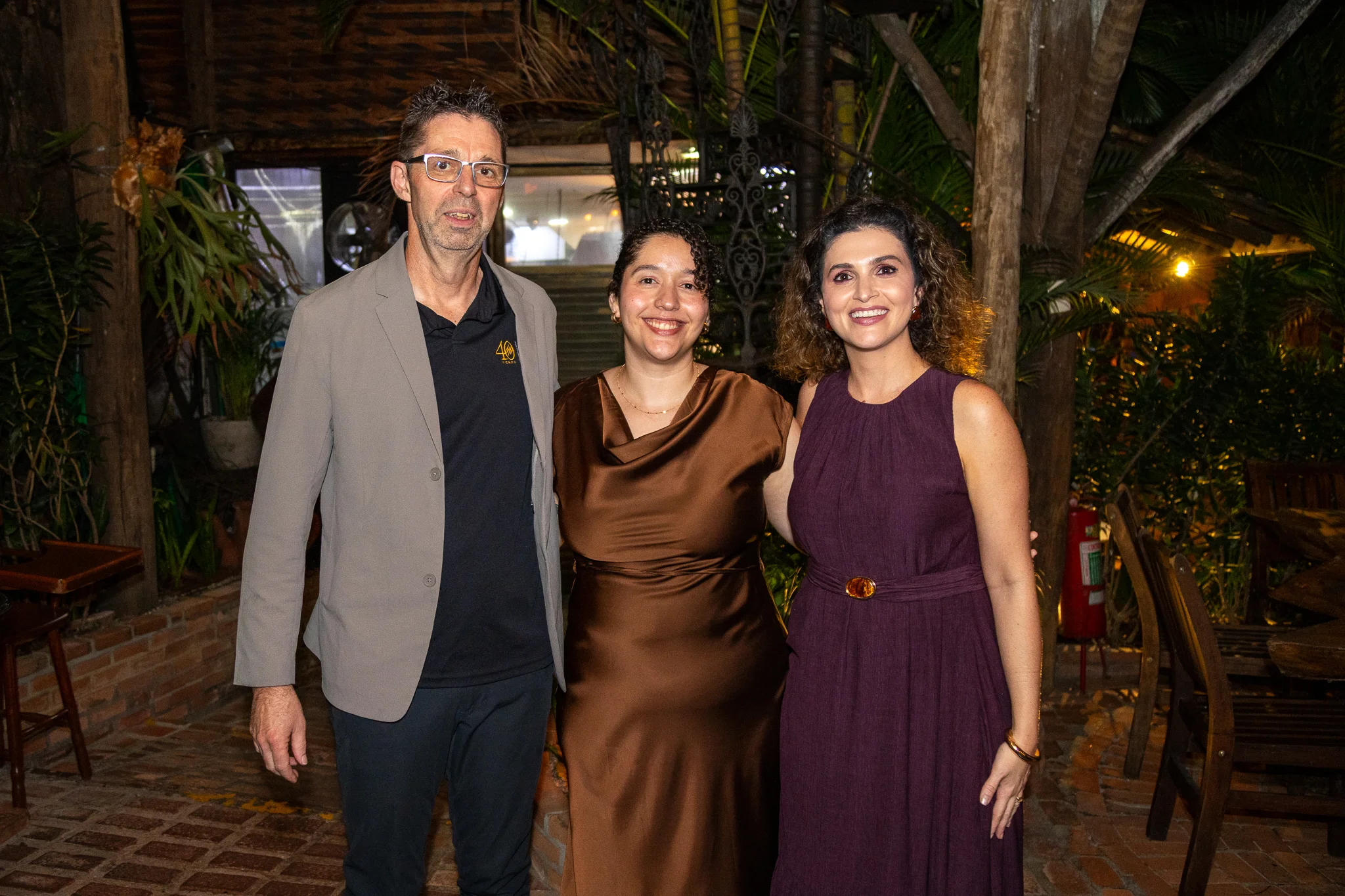 Three Brazil team members at the 40th anniversary celebration