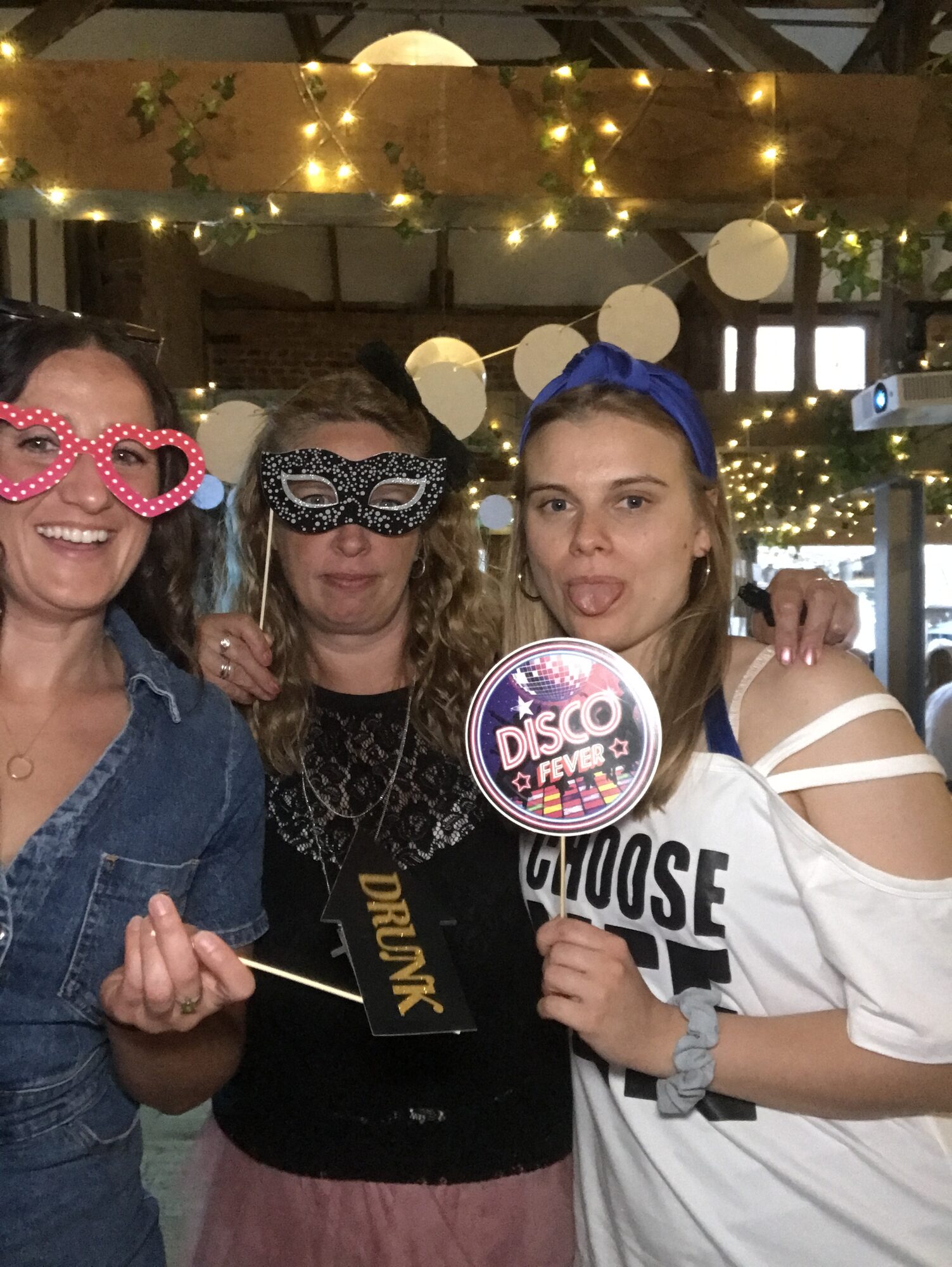 UK team members in the photobooth holding a novelty sign