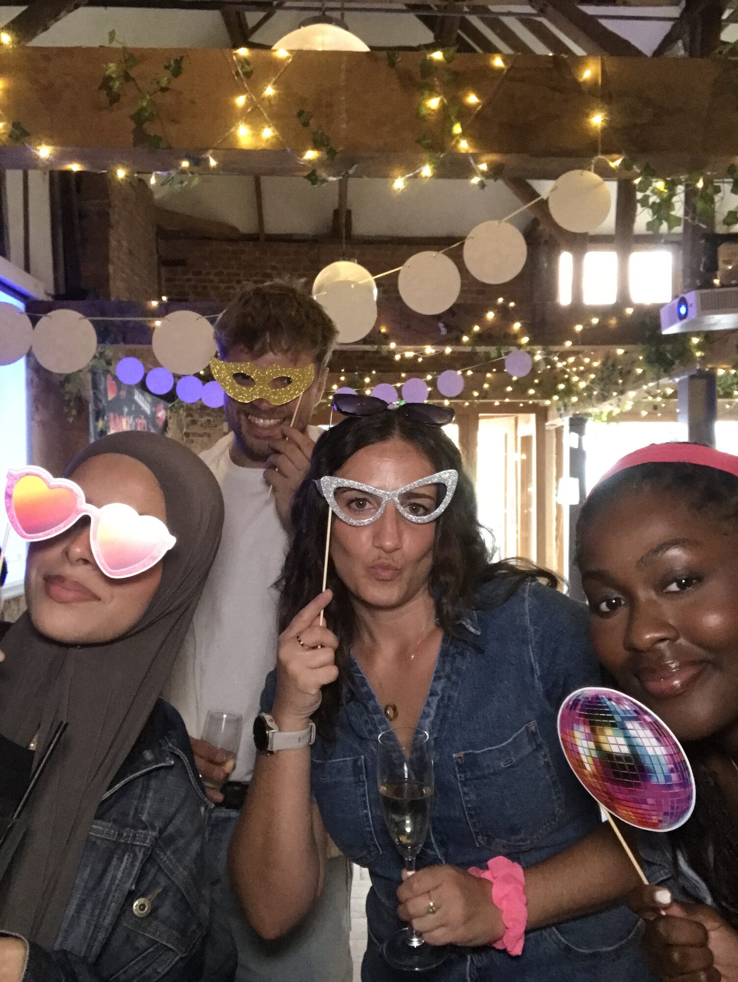 UK team member in the photobooth wearing star-shaped glasses