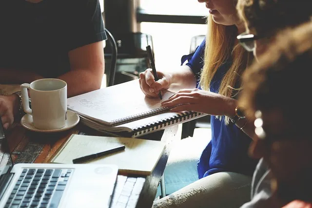 A woman taking notes in a meeting