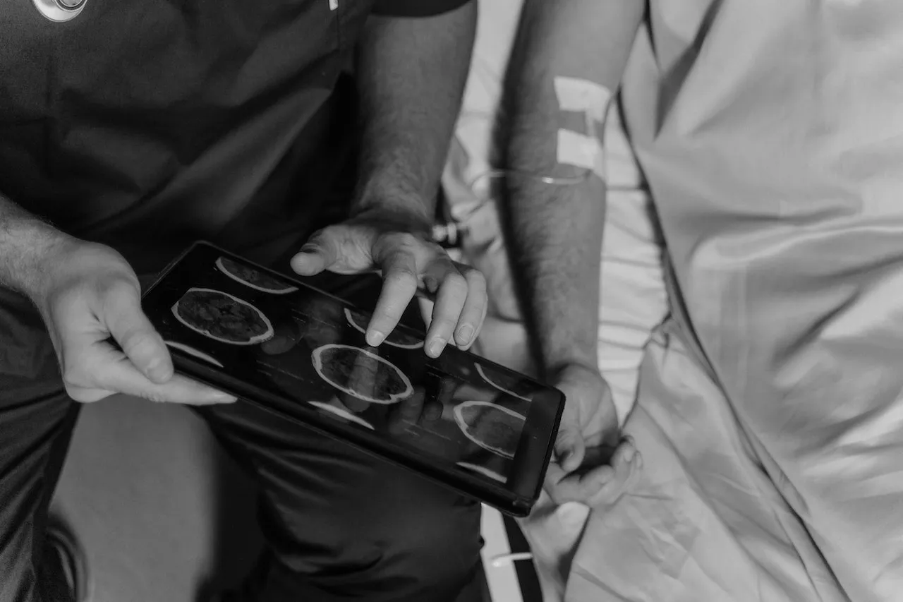 a patient having their scan explained to them by a doctor