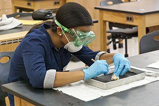 a girl dissecting an isolated eye