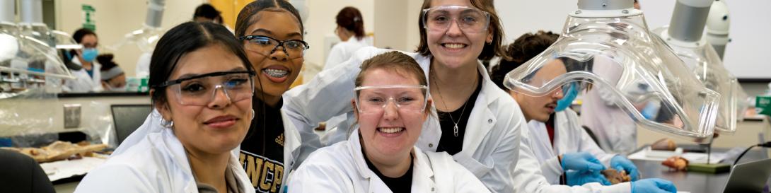 A photograph of smiling students in a laboratory.